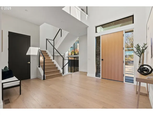 a view of an entryway with wooden floor and stairs