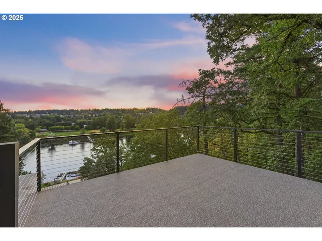 an aerial view of residential house with outdoor space and lake view