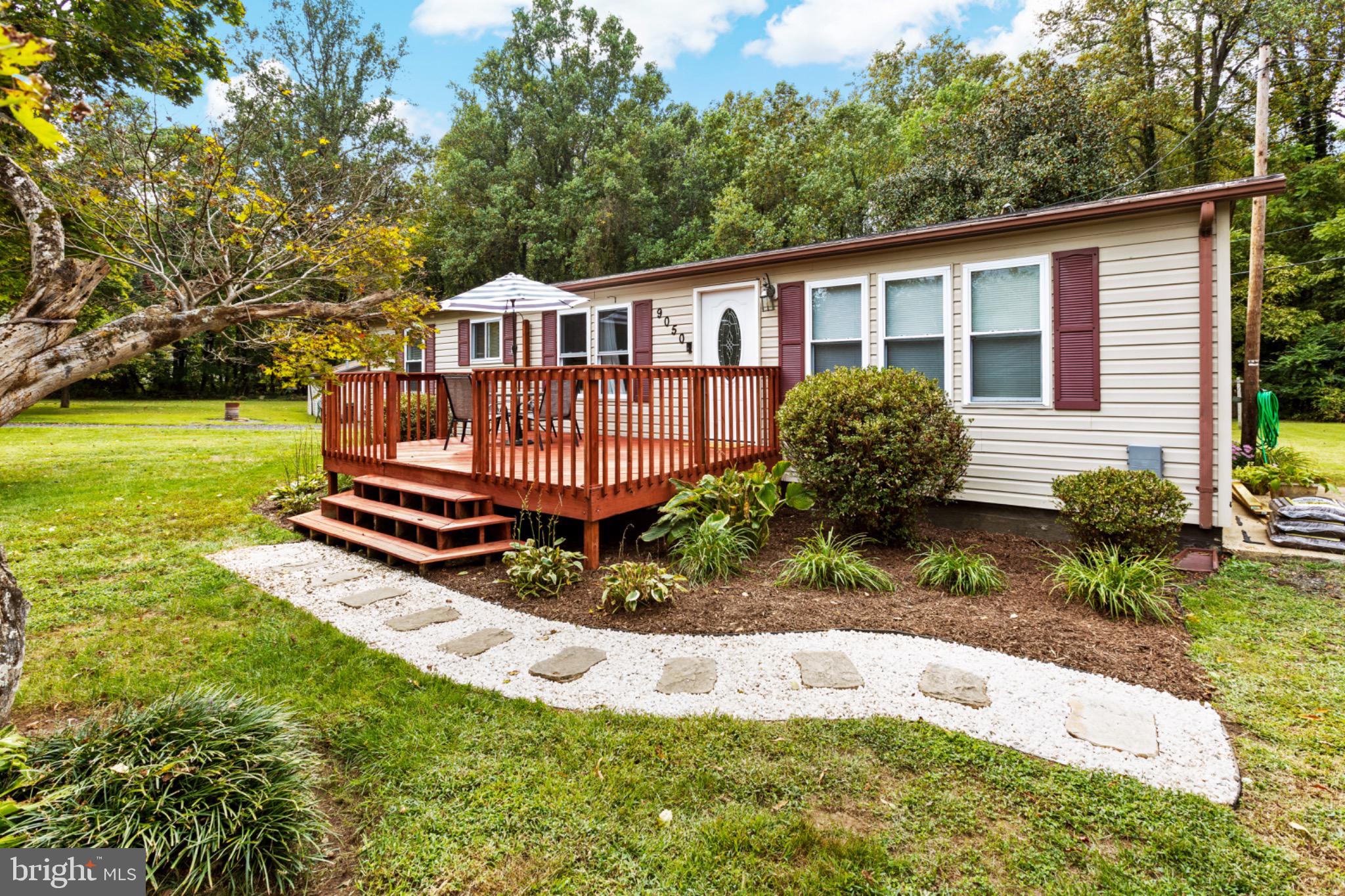 a front view of a house with a yard table and chairs
