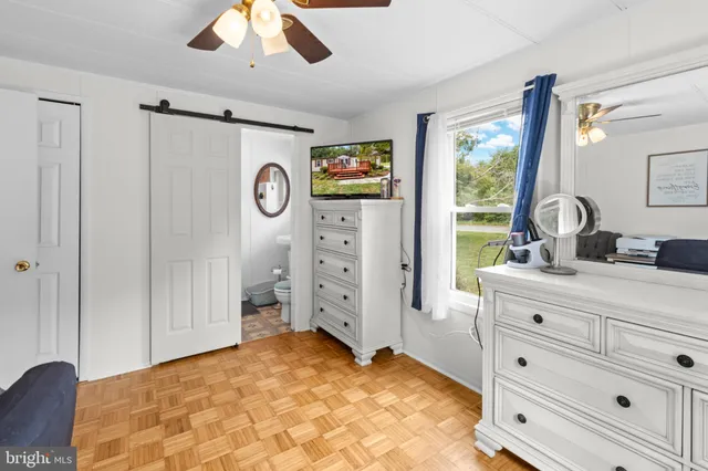 a spacious bedroom with a large bed and a dresser