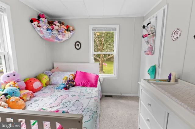 a bedroom with a bed and a dresser in it