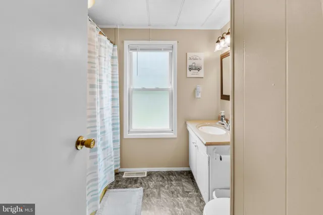 a bathroom with a shower and a sink
