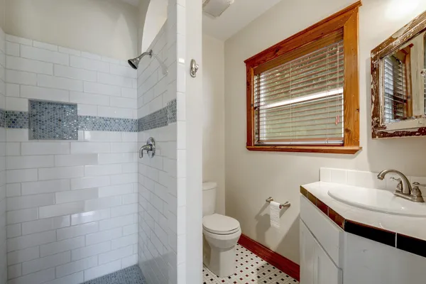 a bathroom with a sink toilet and shower