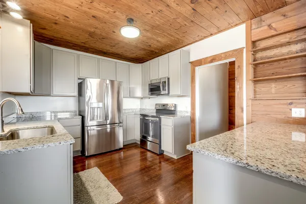 a kitchen with refrigerator and microwave