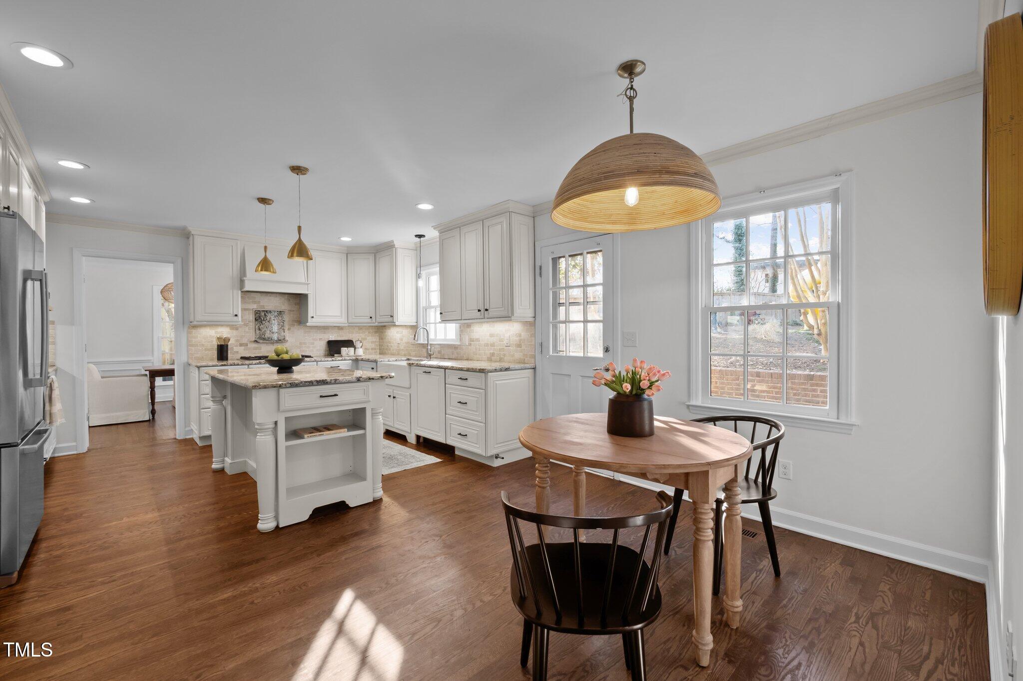 3930 St Marks Road Durham, NC 27707 - Photo 15 of 41 a kitchen with a table chairs stove and cabinets