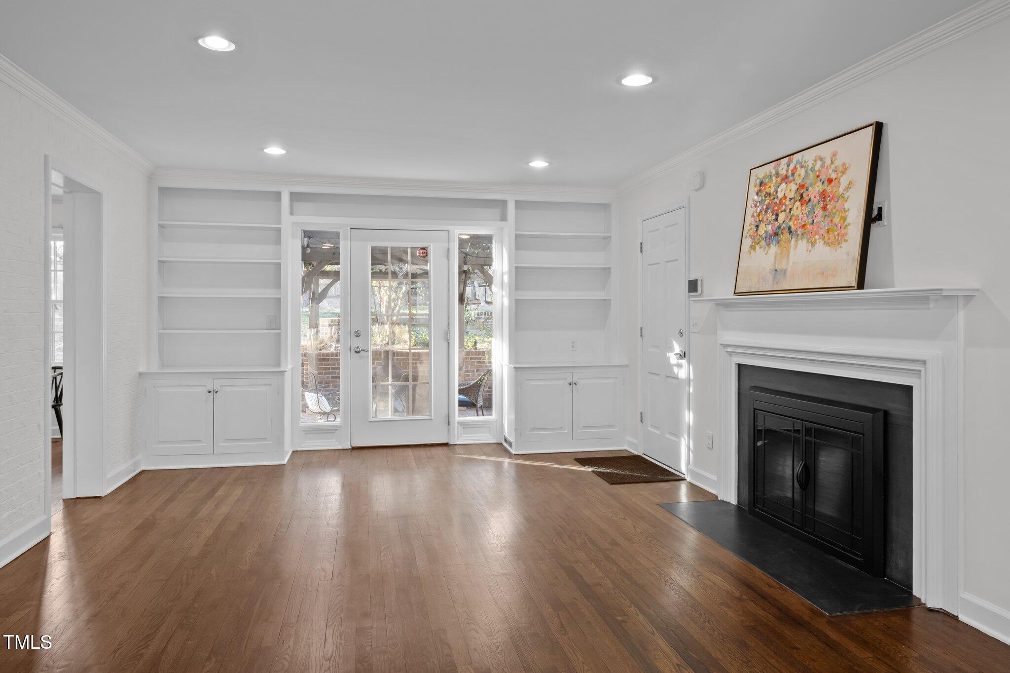 3930 St Marks Road Durham, NC 27707 - Photo 18 of 41 a view of an empty room with wooden floor fireplace and a window