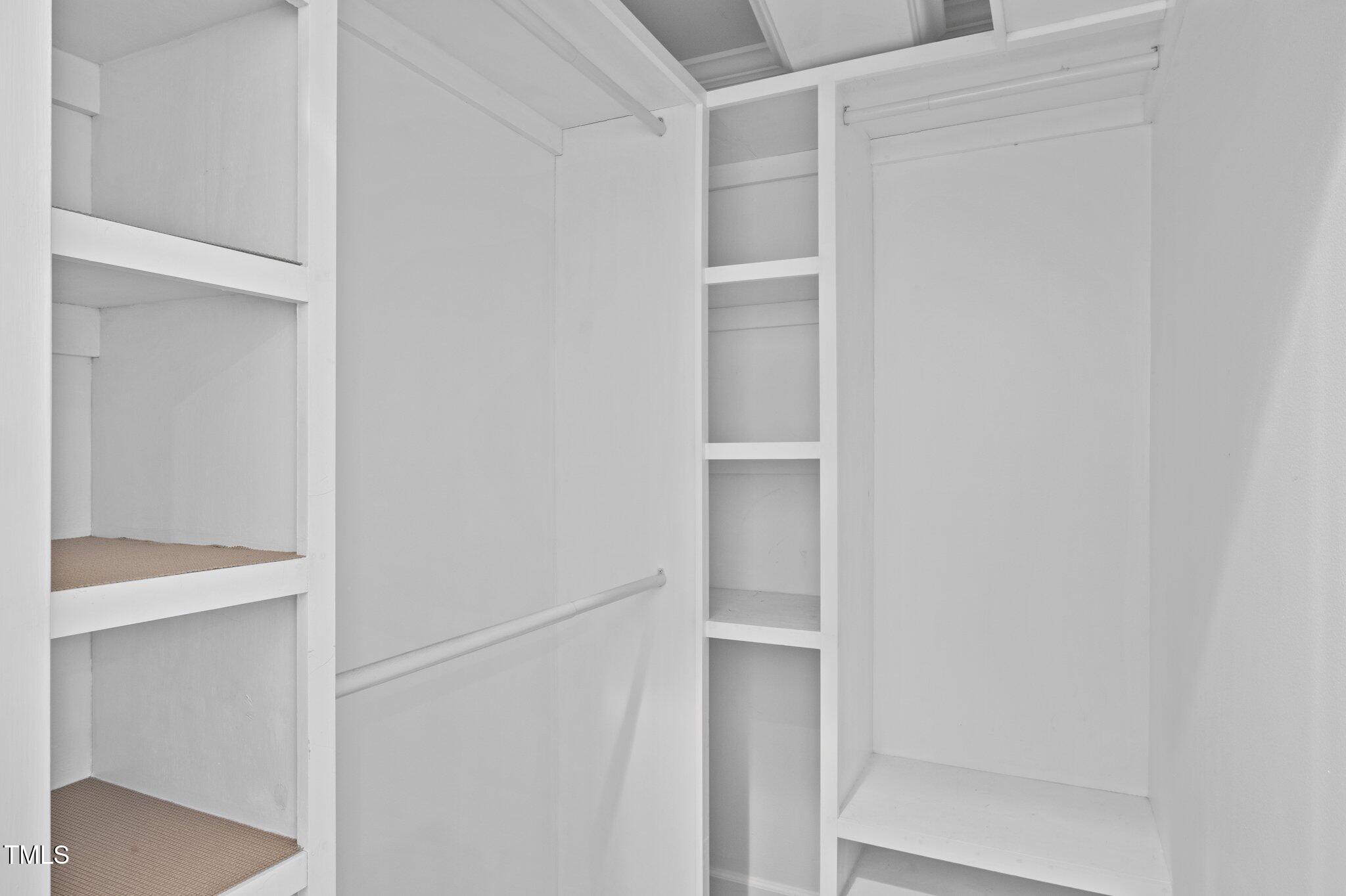 3930 St Marks Road Durham, NC 27707 - Photo 21 of 41 a view of walk in closet with empty racks
