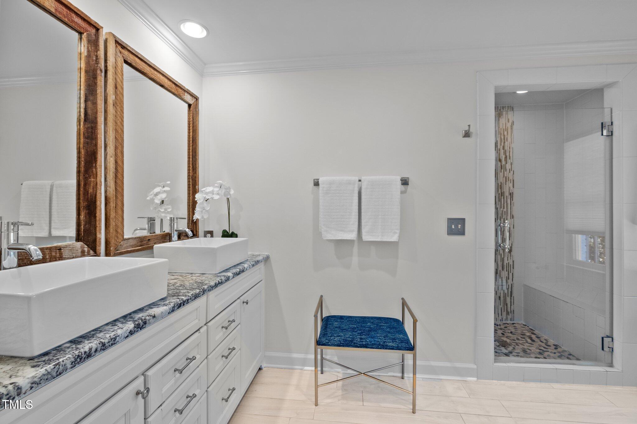 3930 St Marks Road Durham, NC 27707 - Photo 22 of 41 a spacious bathroom with a granite countertop sink a mirror and shower