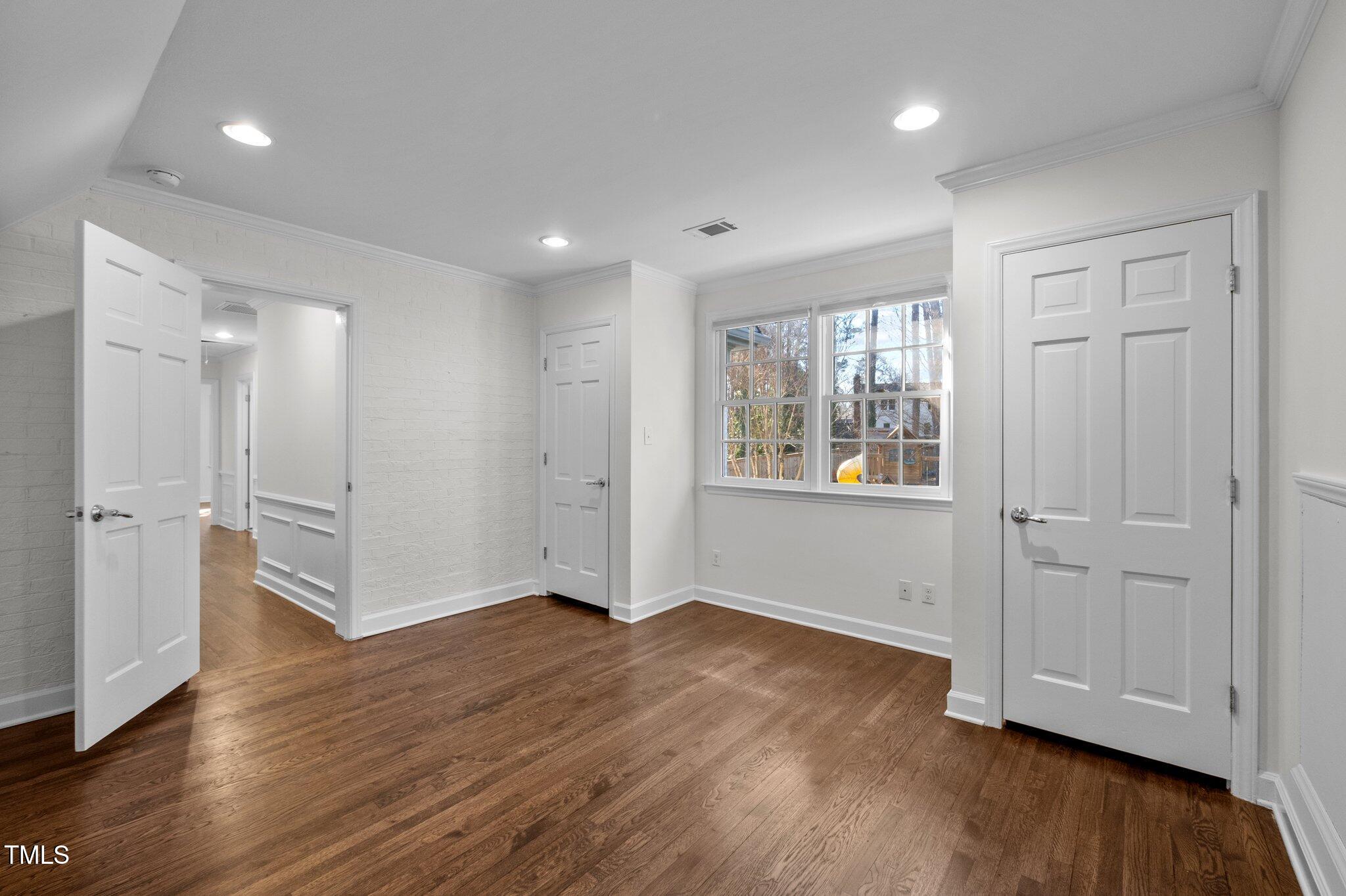 3930 St Marks Road Durham, NC 27707 - Photo 23 of 41 a view of an empty room with wooden floor and a window