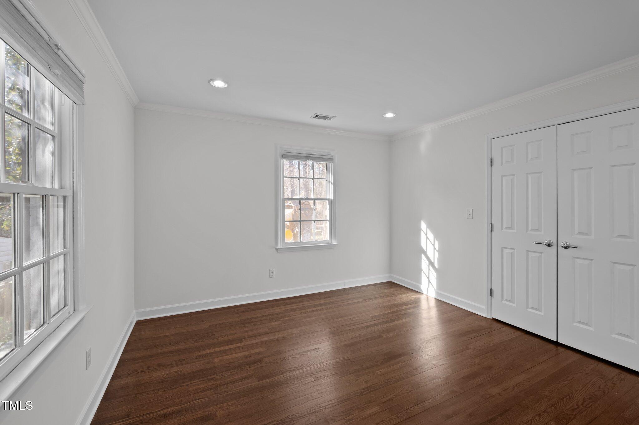 3930 St Marks Road Durham, NC 27707 - Photo 27 of 41 a view of an empty room with wooden floor and a window