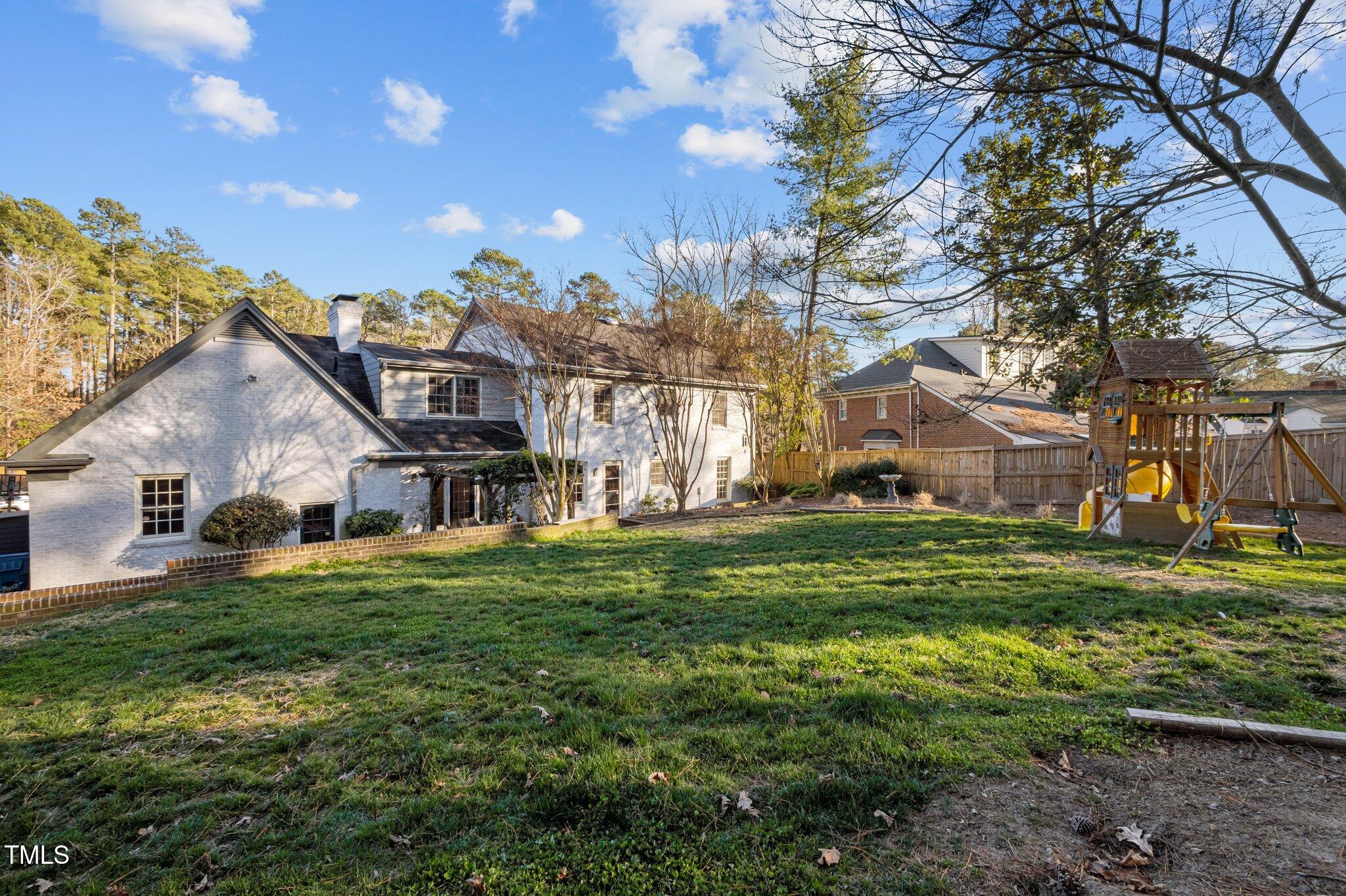 3930 St Marks Road Durham, NC 27707 - Photo 37 of 41 a view of a big house with a big yard and large trees