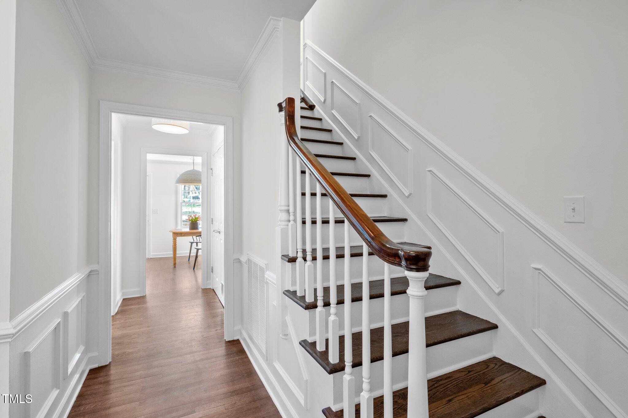 3930 St Marks Road Durham, NC 27707 - Photo 4 of 41 a view of staircase with lots of frames on wall and a window