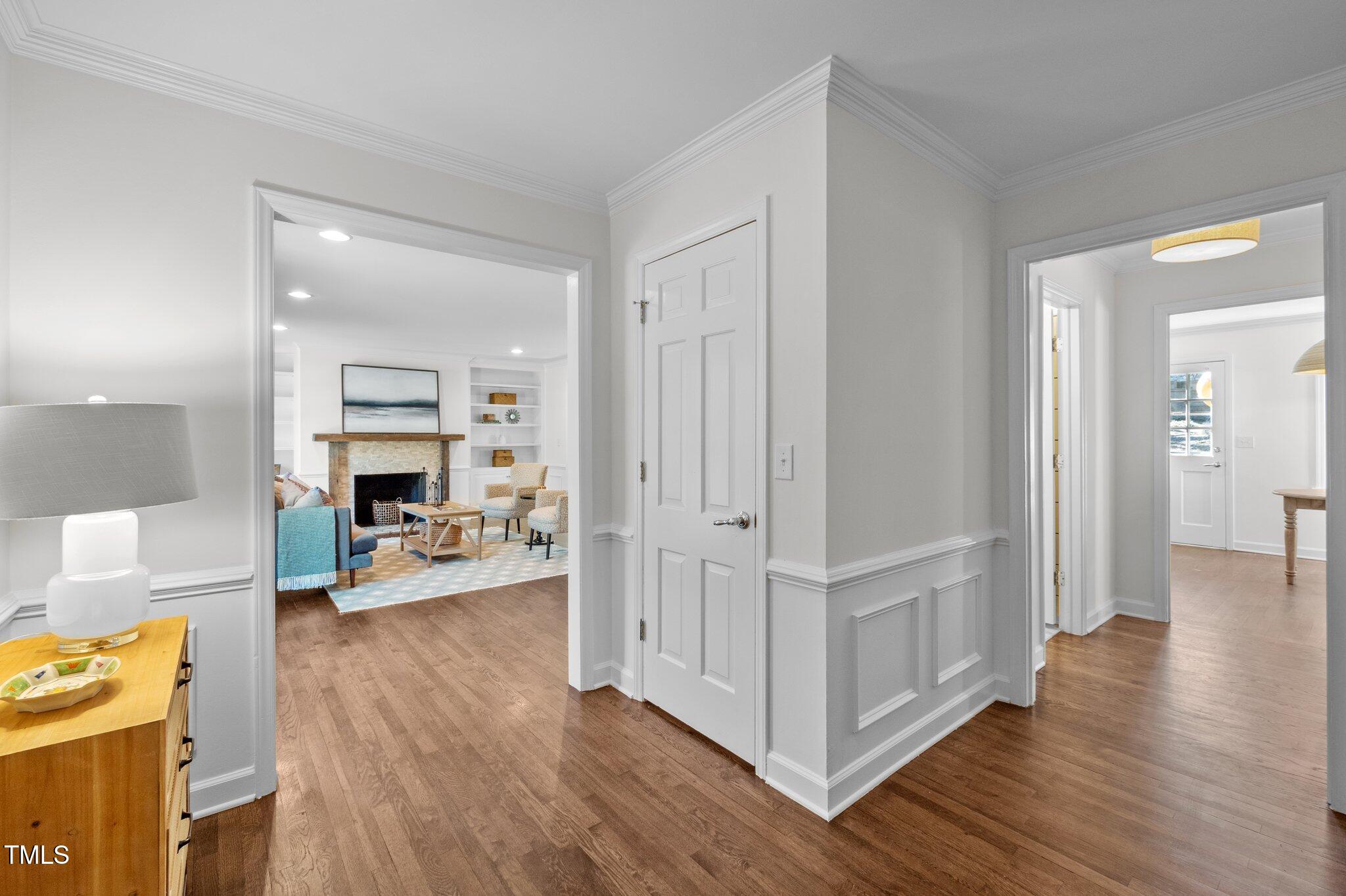 3930 St Marks Road Durham, NC 27707 - Photo 5 of 41 a view of a livingroom with wooden floor a fireplace and entryway