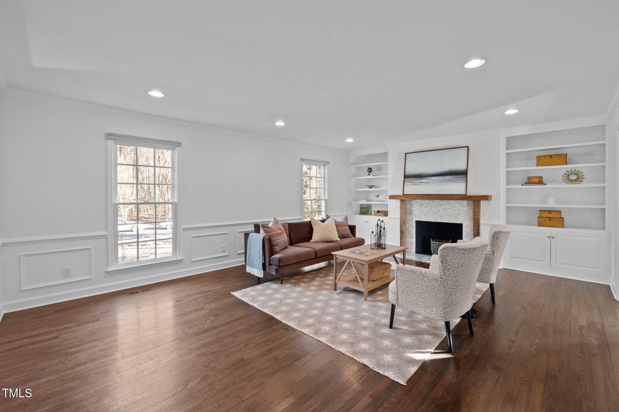 3930 St Marks Road Durham, NC 27707 - Photo 7 of 41 a living room with furniture a fireplace and a large window