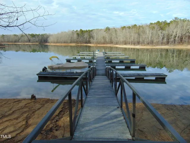 a view of a lake with couches chairs