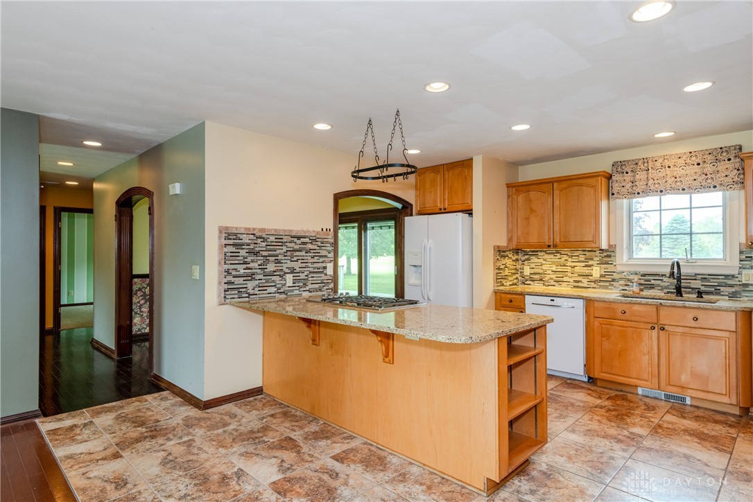9981 Ridge Acres Lane Englewood, OH 45322 - Photo 12 of 73 This spacious kitchen offers a functional layout with ample counter space and natural light.