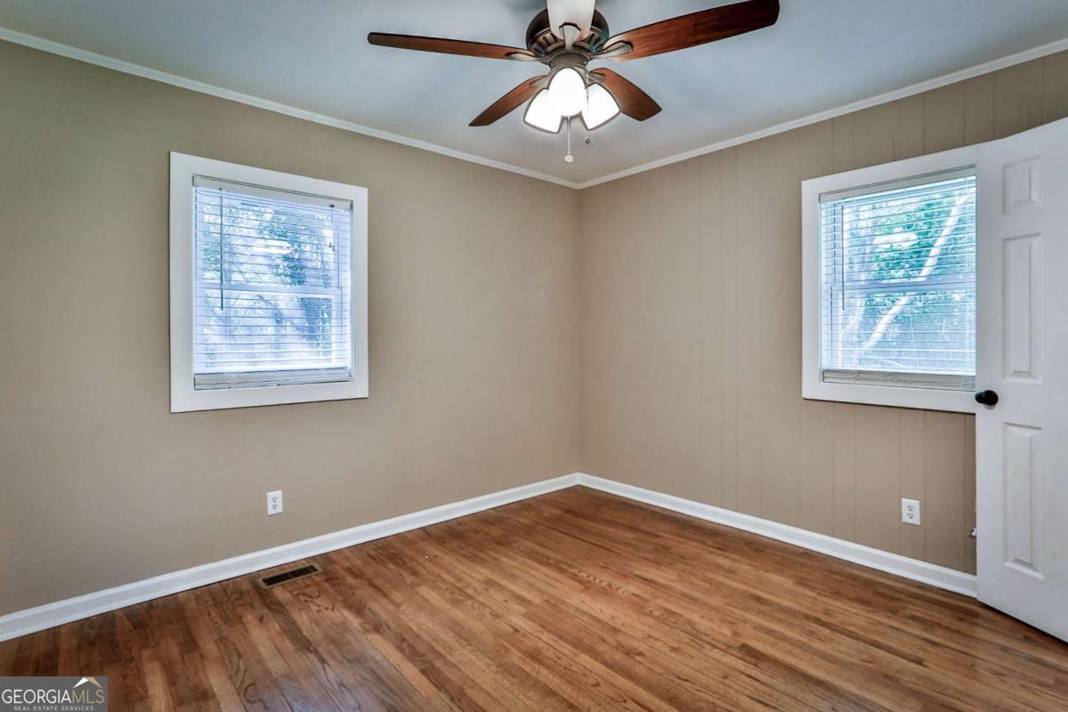 680 North Avenue Madison, GA 30650 - Photo 13 of 20 a view of an empty room with wooden floor and a window