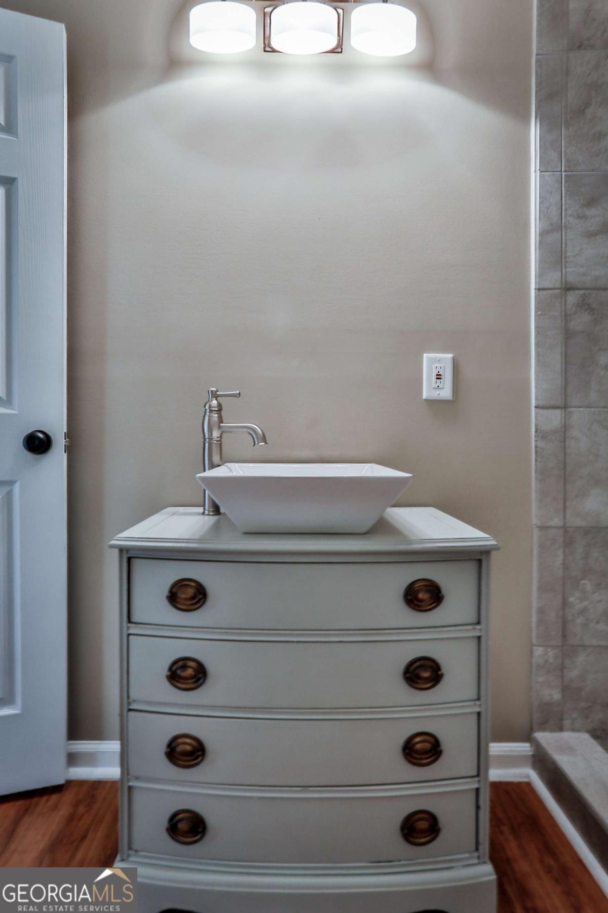 680 North Avenue Madison, GA 30650 - Photo 14 of 20 a bathroom with a sink and a mirror