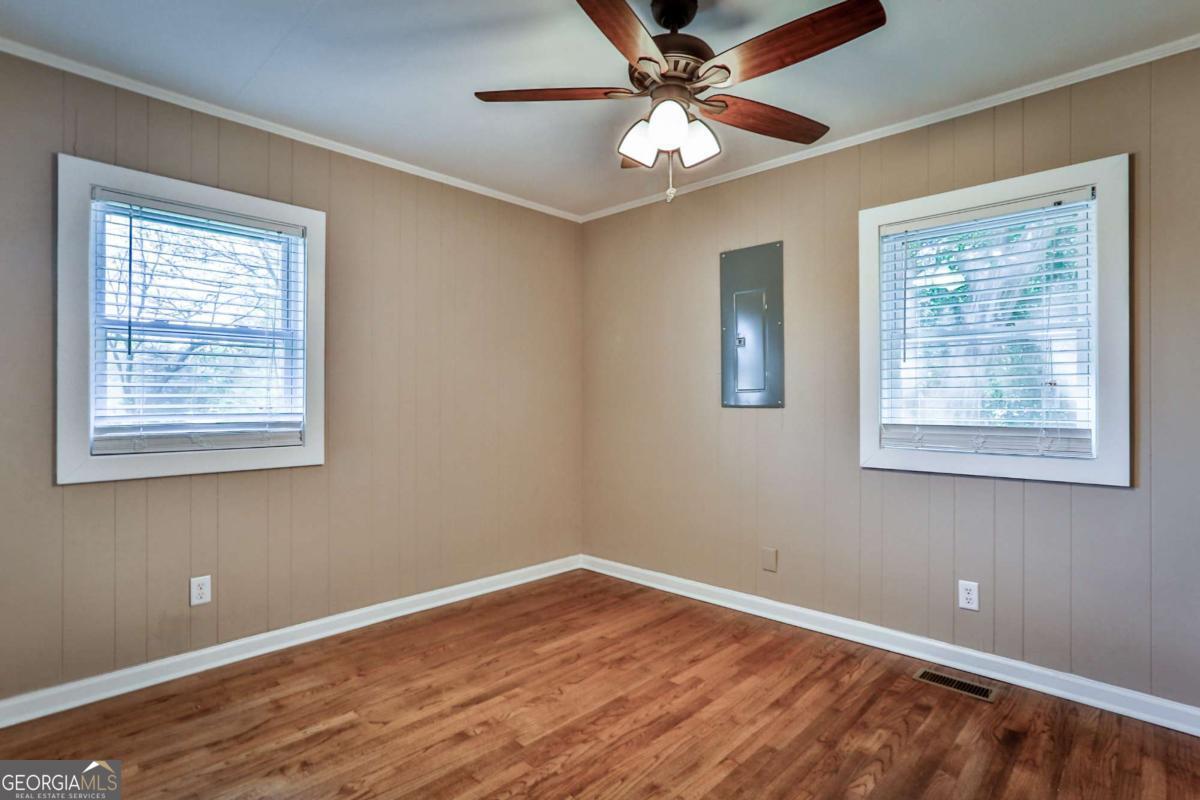 680 North Avenue Madison, GA 30650 - Photo 16 of 20 a view of an empty room with wooden floor and a window