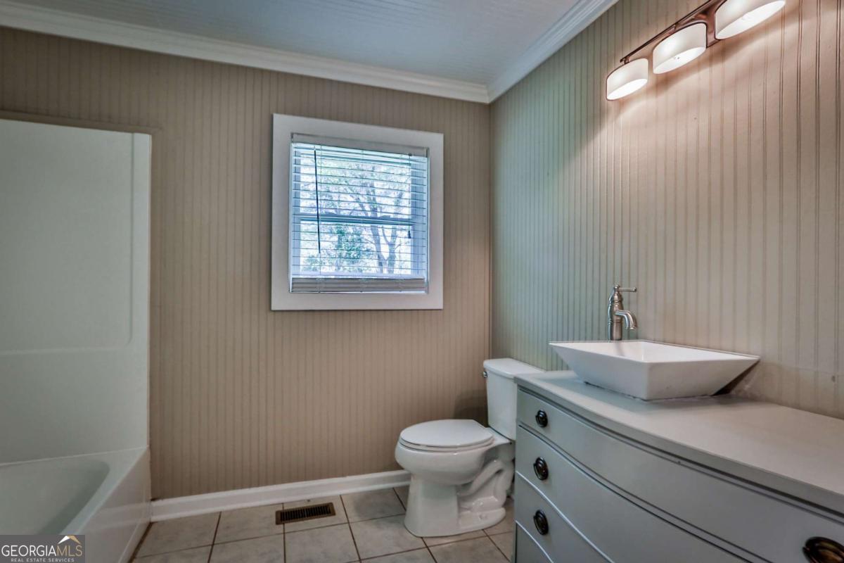 680 North Avenue Madison, GA 30650 - Photo 20 of 20 a bathroom with a toilet a sink and mirror