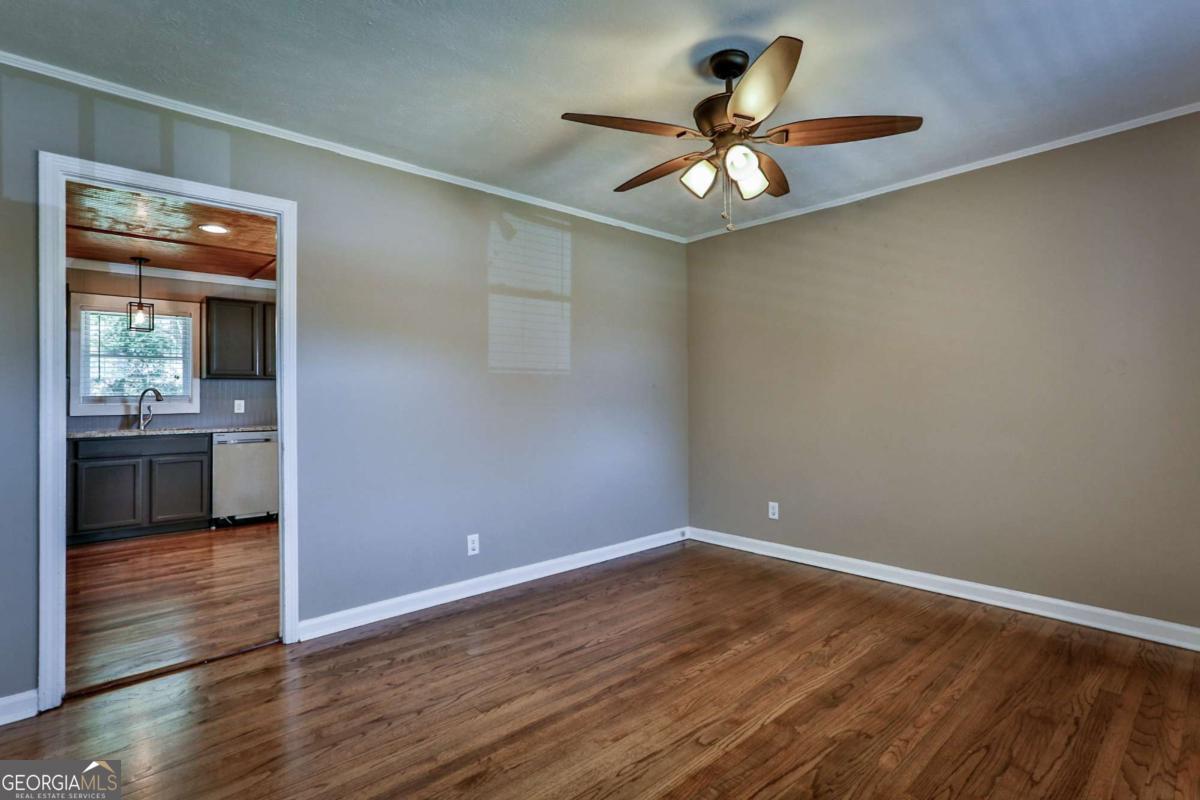 680 North Avenue Madison, GA 30650 - Photo 8 of 20 wooden floor in an empty room with a window