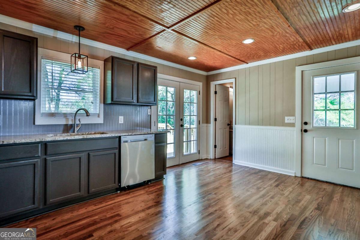 680 North Avenue Madison, GA 30650 - Photo 9 of 20 a kitchen with granite countertop wooden floors and sink
