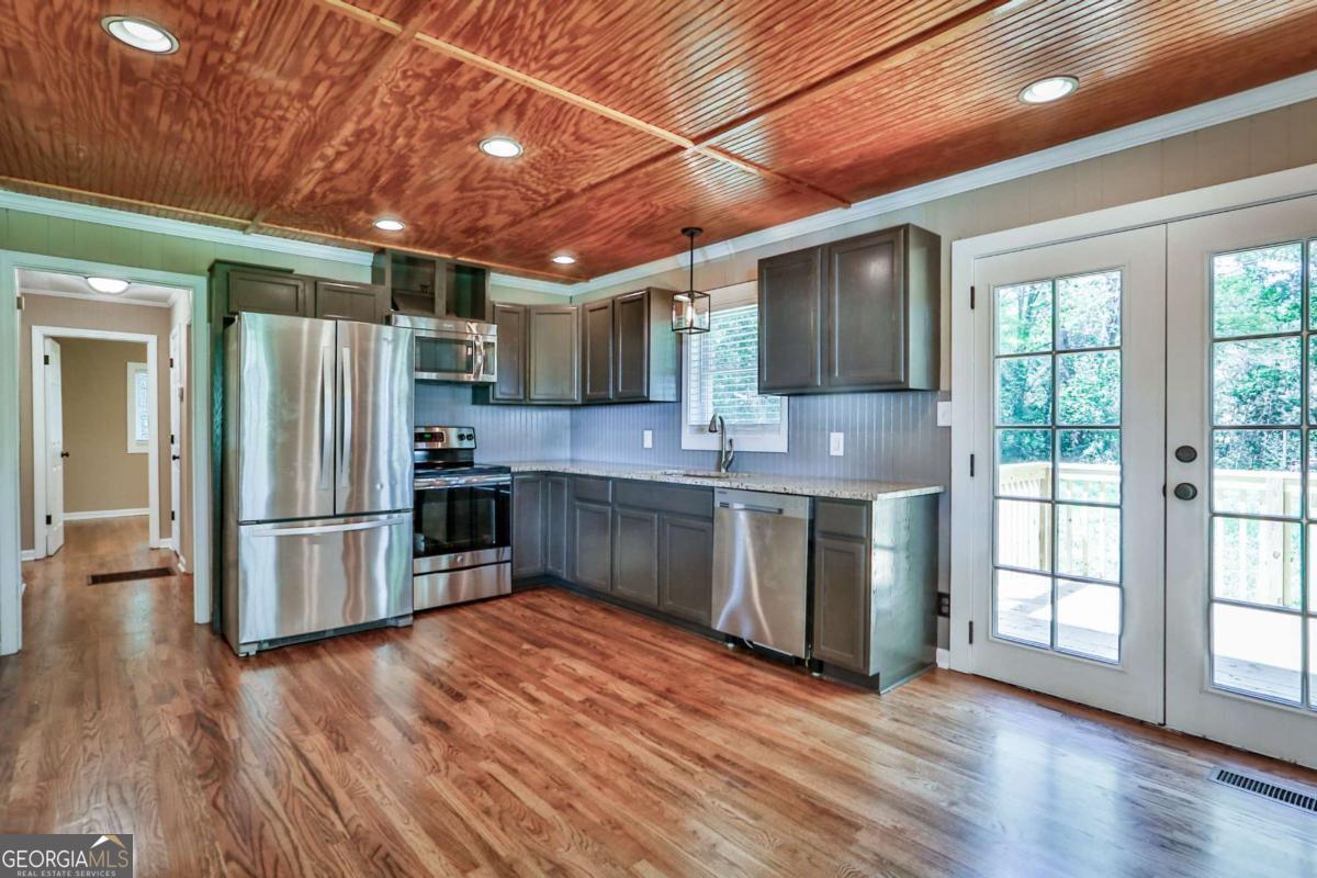 680 North Avenue Madison, GA 30650 - Photo 10 of 20 a kitchen with stainless steel appliances granite countertop a refrigerator and a stove