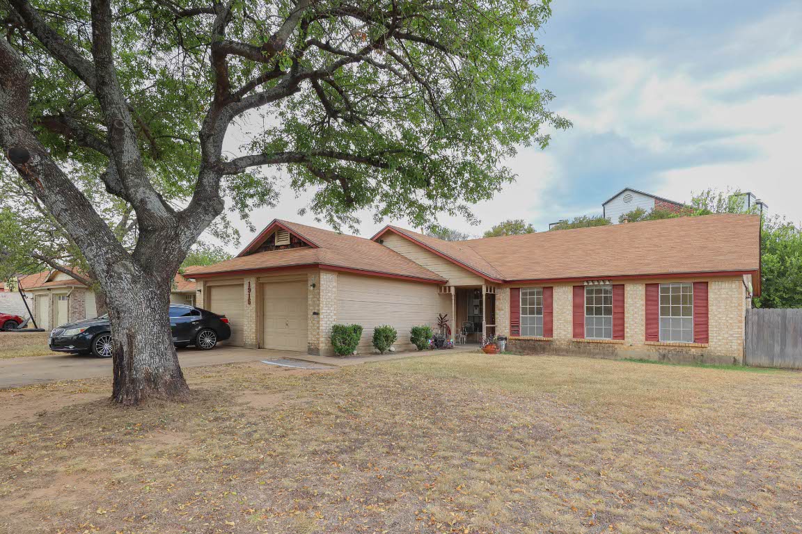 1915 Prairie Knoll Court, Unit B Austin, TX 78758 - Photo 1 of 15 a white house that has a tree in front of it