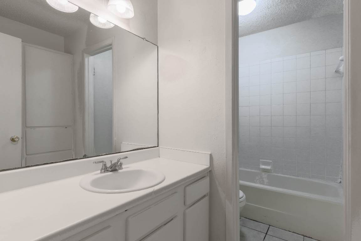 1915 Prairie Knoll Court, Unit B Austin, TX 78758 - Photo 11 of 15 a bathroom with a sink and a mirror