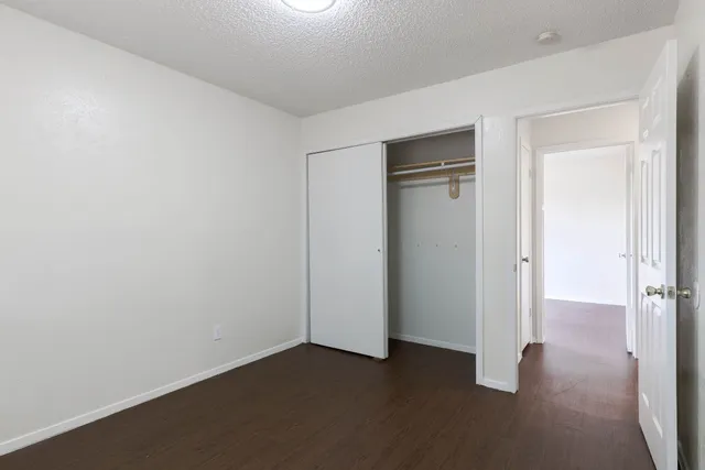 an empty room with closet area