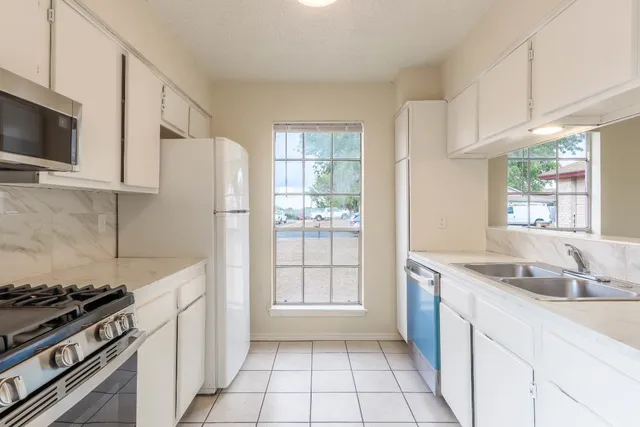a kitchen with a stove a sink and a refrigerator