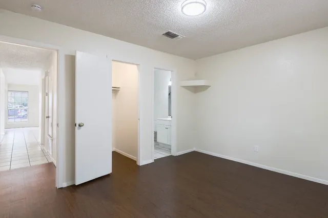 a view of empty room with wooden floor