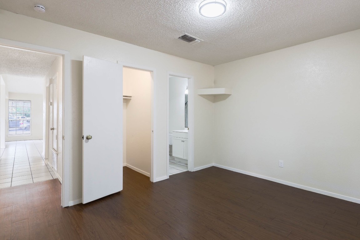 1915 Prairie Knoll Court, Unit B Austin, TX 78758 - Photo 7 of 15 a view of empty room with wooden floor