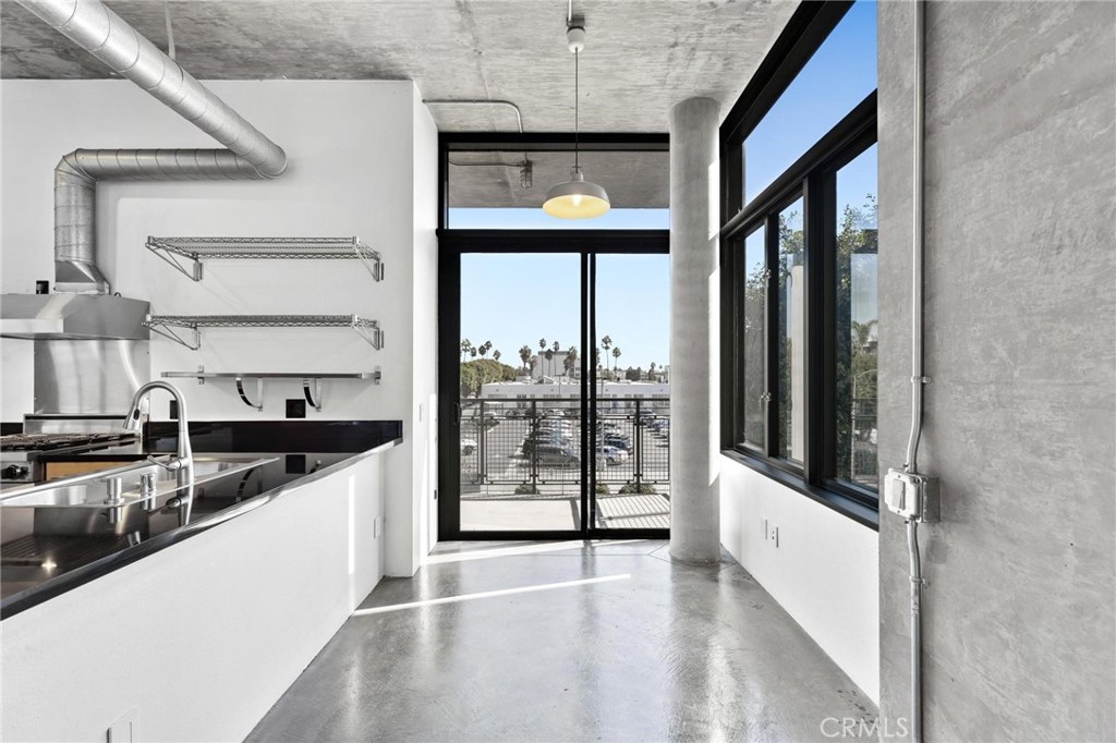 835 Locust Avenue, Unit 322 Long Beach, CA 90813 - Photo 11 of 42 a kitchen with stainless steel appliances granite countertop a stove and a refrigerator