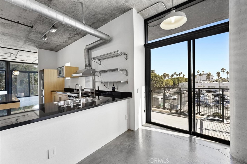 835 Locust Avenue, Unit 322 Long Beach, CA 90813 - Photo 12 of 42 a large white kitchen with a large window