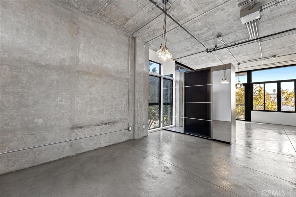 835 Locust Avenue, Unit 322 Long Beach, CA 90813 - Photo 25 of 42 a view of an empty room with wooden floor and a window
