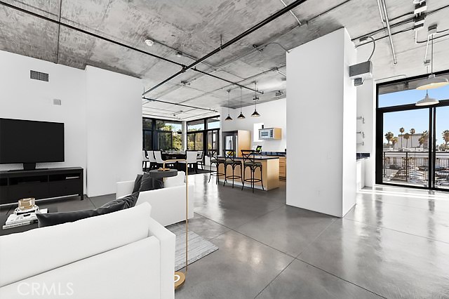 835 Locust Avenue, Unit 322 Long Beach, CA 90813 - Photo 4 of 42 a living room with furniture and a flat screen tv
