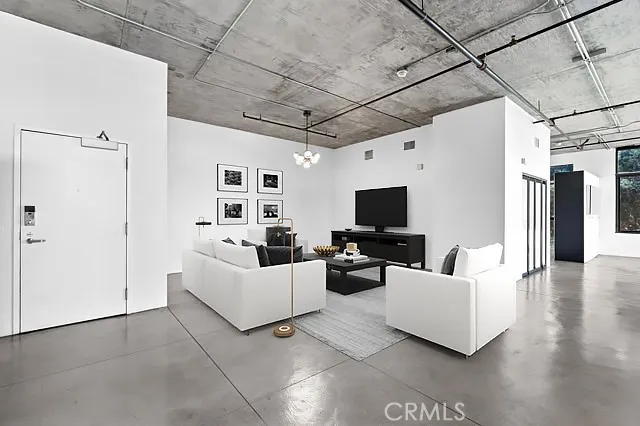 a living room with furniture and a chandelier