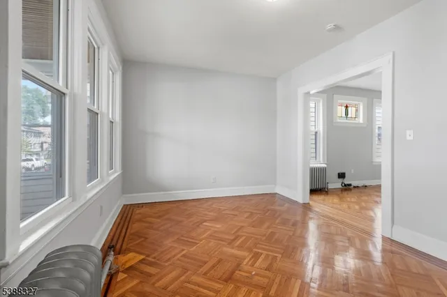 a view of room with window and a ceiling fan