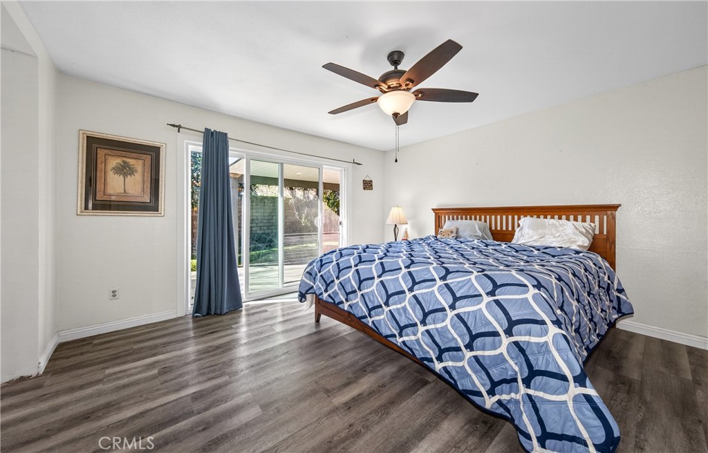 2158 North Magnolia Avenue Rialto, CA 92377 - Photo 15 of 23 a bedroom with a bed and wooden floor