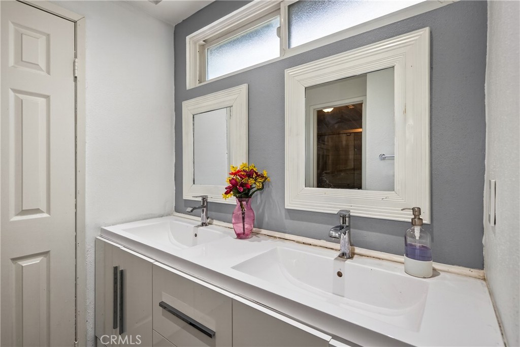2158 North Magnolia Avenue Rialto, CA 92377 - Photo 16 of 23 a bathroom with a sink and a mirror