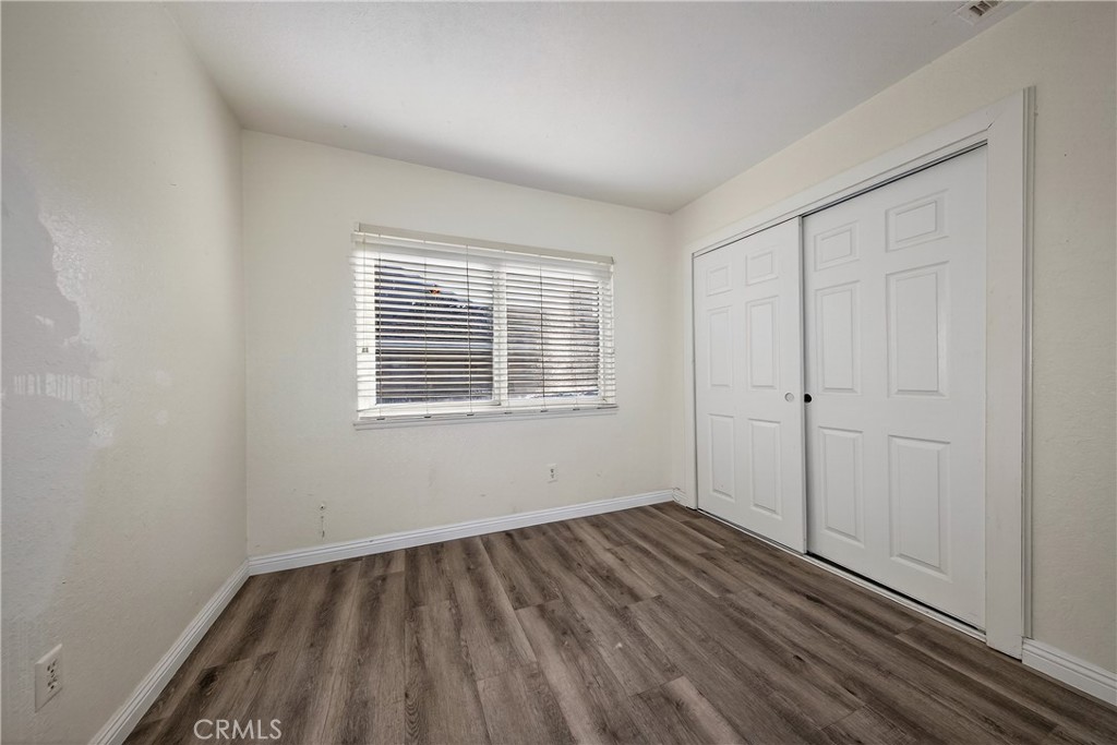 2158 North Magnolia Avenue Rialto, CA 92377 - Photo 19 of 23 a view of a room with wooden floor and windows