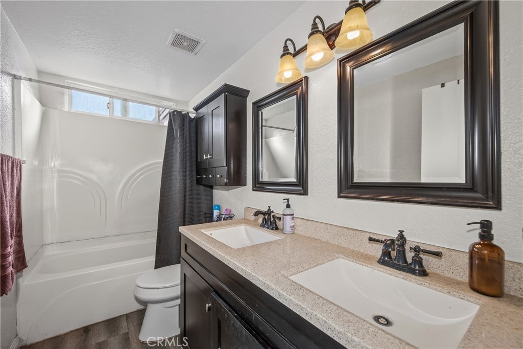 2158 North Magnolia Avenue Rialto, CA 92377 - Photo 20 of 23 a bathroom with a granite countertop sink toilet and shower