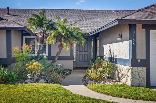 a front view of a house with garden
