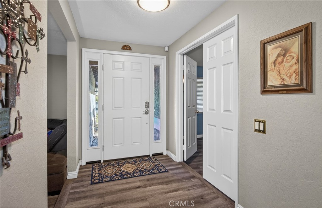 2158 North Magnolia Avenue Rialto, CA 92377 - Photo 4 of 23 a view of a hallway with wooden floor and a living room