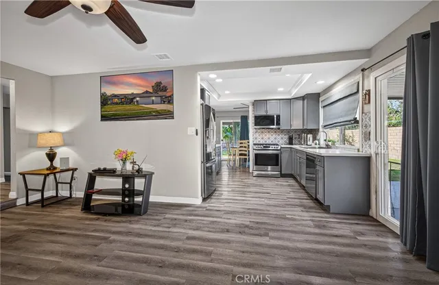 a living room with stainless steel appliances kitchen island granite countertop furniture and a kitchen view