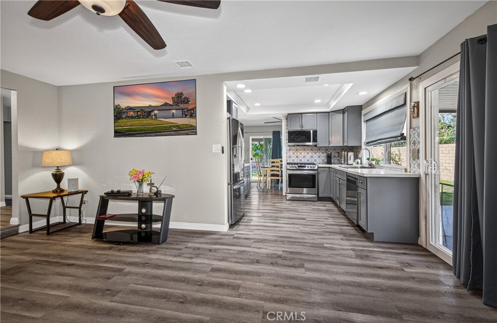 2158 North Magnolia Avenue Rialto, CA 92377 - Photo 7 of 23 a living room with stainless steel appliances kitchen island granite countertop furniture and a kitchen view