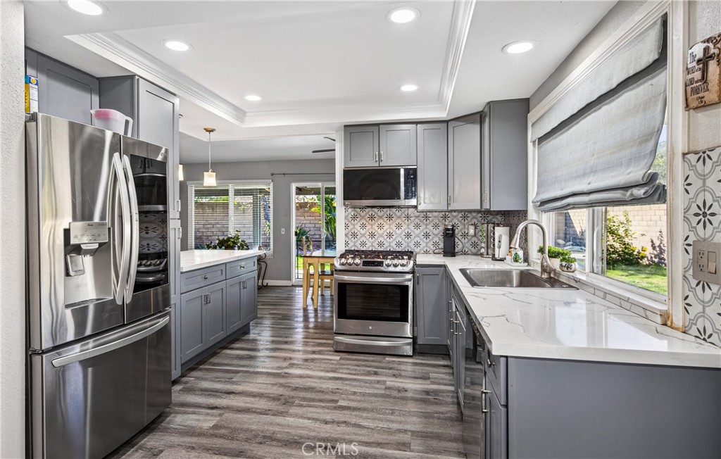 2158 North Magnolia Avenue Rialto, CA 92377 - Photo 8 of 23 a kitchen with stainless steel appliances a refrigerator sink and microwave