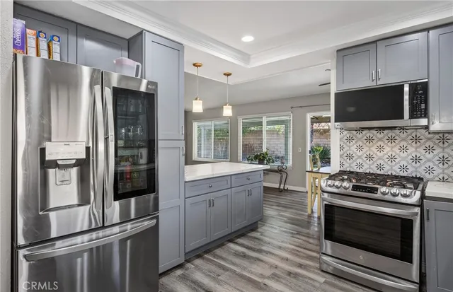 a kitchen with a refrigerator stove and microwave