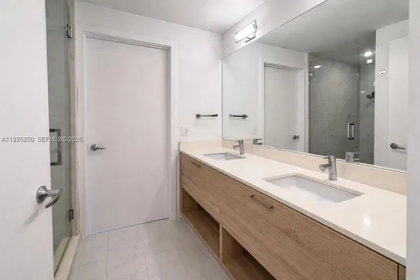 a bathroom with a double vanity sink mirror and double